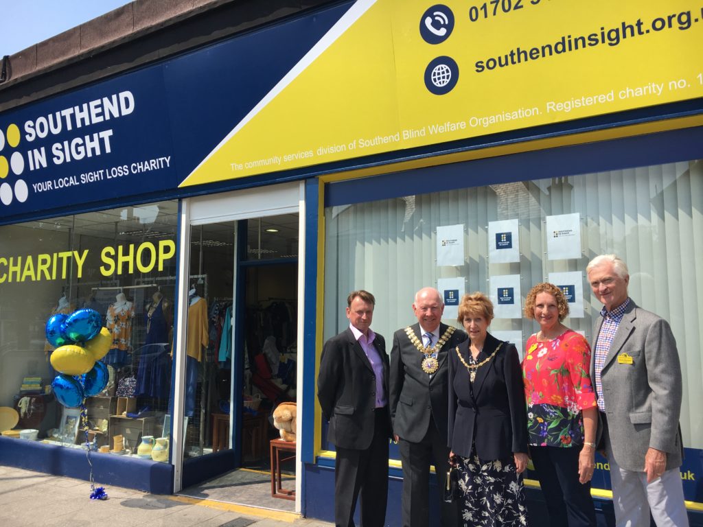 Photo shows a former Mayor and Mayoress with trustees outside our charity shop.