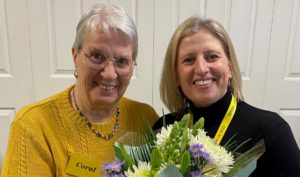 Picture shows CEO Lucy presenting Coral with flowers at the Macular Group.