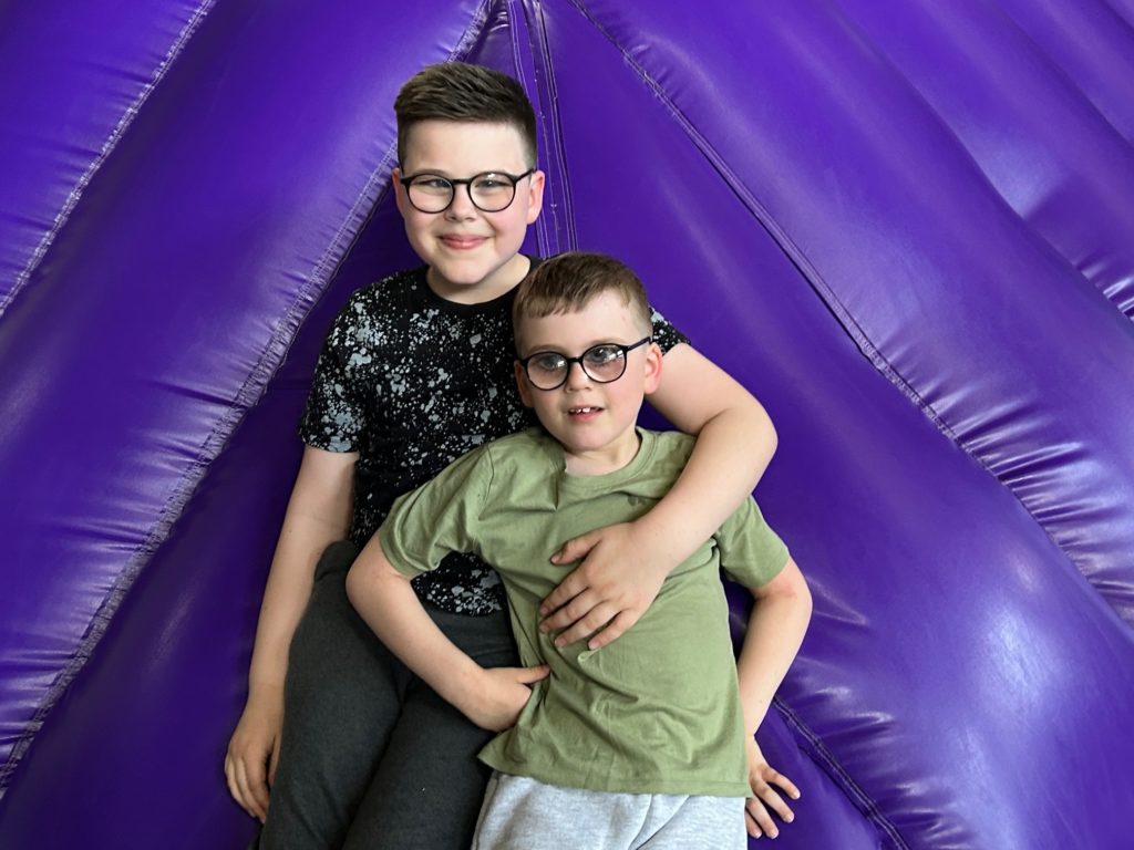 Photo shows brothers Jude and Sidney sliding down Jelly Mountain at Kids Kingdom