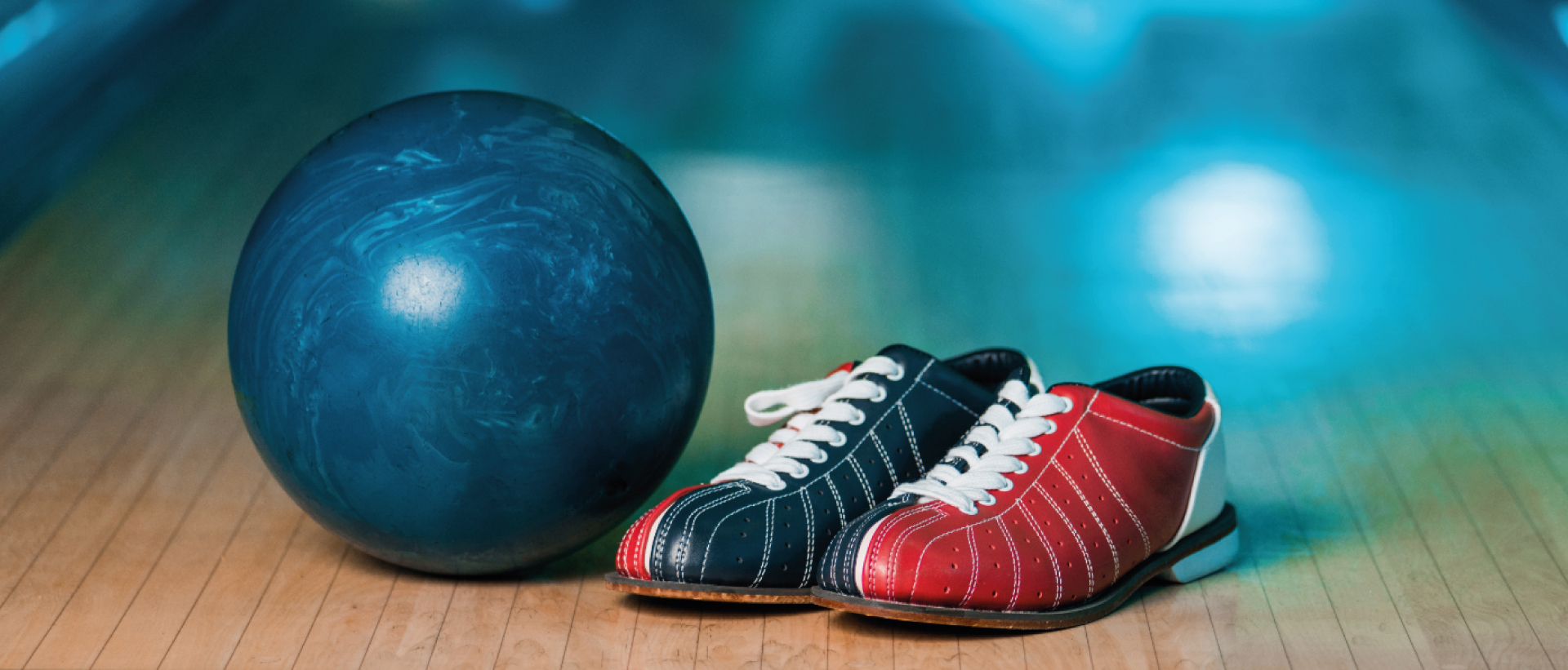 Photo shows a bowling ball and shoes.